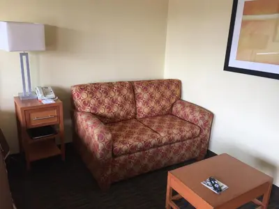 a living room with a couch and a table at Howard Johnson by Wyndham San Diego Sea World in San Diego