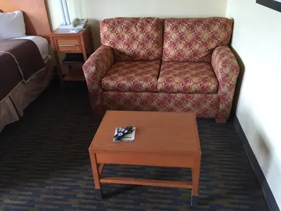 a living room with a couch and a coffee table at Howard Johnson by Wyndham San Diego Sea World in San Diego