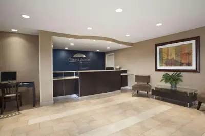 a lobby with a waiting area with a desk and chairs at Howard Johnson by Wyndham San Diego Sea World in San Diego