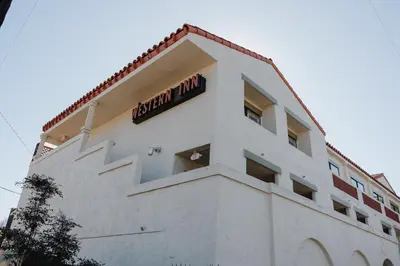 a white building with a sign on top of it at Old Town Western Inn in San Diego