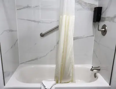 a shower with a shower curtain in a bathroom at Old Town Western Inn in San Diego