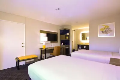a hotel room with two beds and a desk at Comfort Inn Encinitas Near Legoland in Encinitas