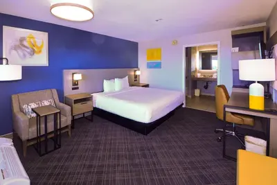 a hotel room with a bed and a chair at Comfort Inn Encinitas Near Legoland in Encinitas