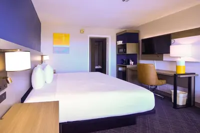 a hotel room with a large bed and a desk at Comfort Inn Encinitas Near Legoland in Encinitas