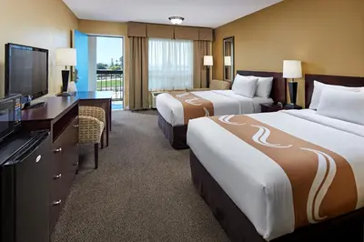 a hotel room with two beds and a flat screen tv at Comfort Inn Encinitas Near Legoland in Encinitas