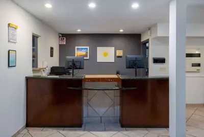 a lobby with a reception desk with two computers at Days Inn by Wyndham Encinitas Moonlight Beach in Encinitas