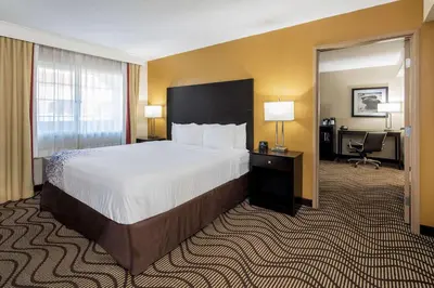 a hotel room with a large bed and a desk at La Quinta by Wyndham Carlsbad - Legoland Area in Carlsbad