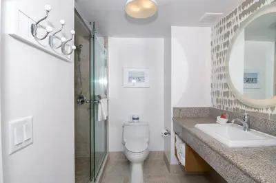 a bathroom with a toilet and a sink and a mirror at Ocean Park Inn in San Diego
