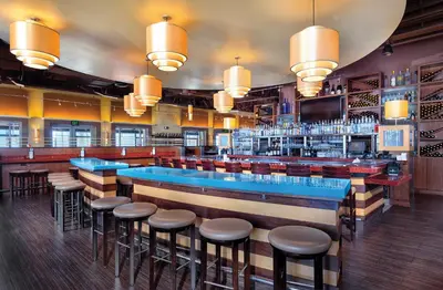 a bar with stools in a restaurant at Club Wyndham Oceanside Pier Resort in Oceanside