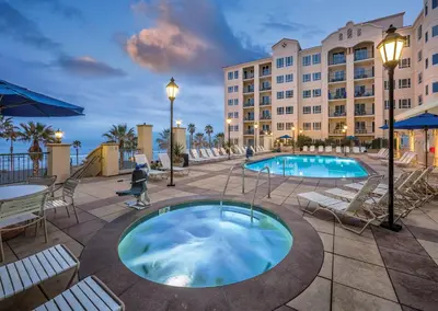 a hotel with a swimming pool and a building at Club Wyndham Oceanside Pier Resort in Oceanside