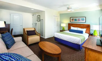 a hotel room with a bed and a couch at Club Wyndham Oceanside Pier Resort in Oceanside