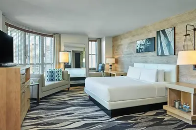 a hotel room with a bed and a living room at Hotel Republic San Diego, Autograph Collection in San Diego