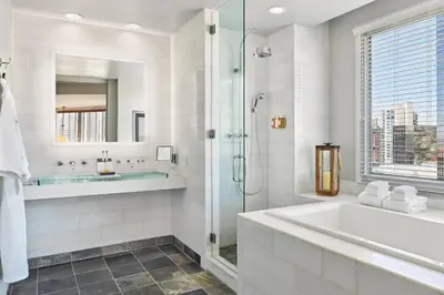 a white bathroom with a tub and a shower at Hotel Republic San Diego, Autograph Collection in San Diego