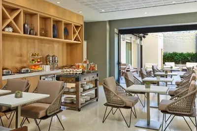 a restaurant with tables and chairs and a counter at Hotel Republic San Diego, Autograph Collection in San Diego