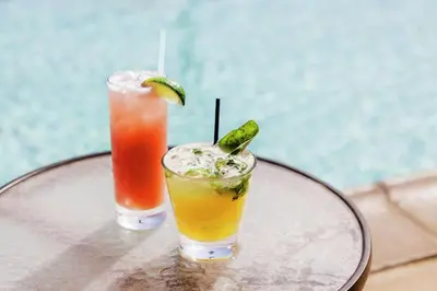 two cocktails sitting on top of a table at The Cassara Carlsbad, Tapestry Collection By Hilton in Carlsbad