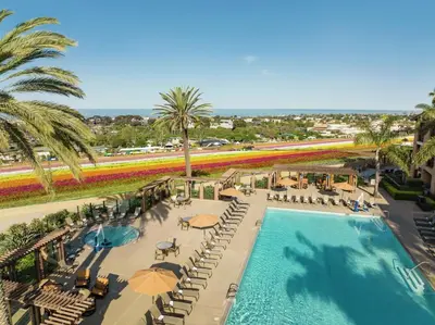 an overhead view of a pool with chairs and umbrellas at The Cassara Carlsbad, Tapestry Collection By Hilton in Carlsbad