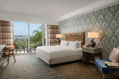 a hotel room with a bed and a balcony at The Cassara Carlsbad, Tapestry Collection By Hilton in Carlsbad