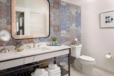 a bathroom with a sink and a toilet and a mirror at The Cassara Carlsbad, Tapestry Collection By Hilton in Carlsbad