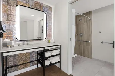a bathroom with a sink and a mirror at The Cassara Carlsbad, Tapestry Collection By Hilton in Carlsbad