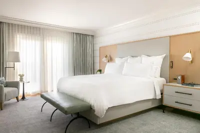 a bedroom with a large white bed and a chair at Waldorf Astoria Monarch Beach Resort & Club in Dana Point