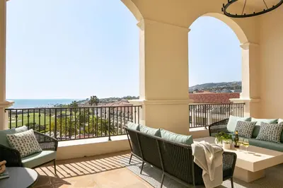 a balcony with chairs and a view of the ocean at Waldorf Astoria Monarch Beach Resort & Club in Dana Point