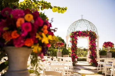 a wedding aisle with chairs and a gazebo with flowers at Waldorf Astoria Monarch Beach Resort & Club in Dana Point