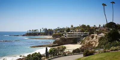 a house on a cliff next to the ocean at Laguna Beach House in Laguna Beach