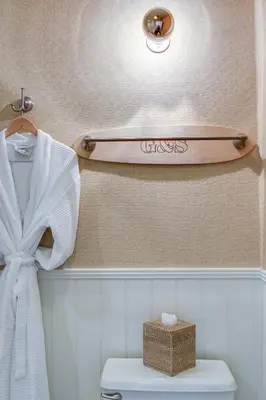 a surfboard on a shelf above a toilet in a bathroom at Laguna Beach House in Laguna Beach