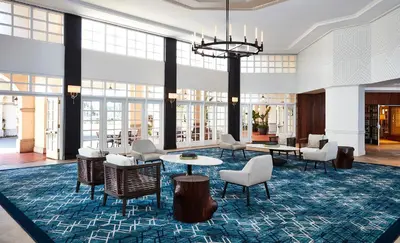 a lobby with chairs and tables and a chandelier at San Diego Mission Bay Resort in San Diego