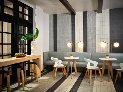 a restaurant with tables and chairs and a bench at San Diego Mission Bay Resort in San Diego