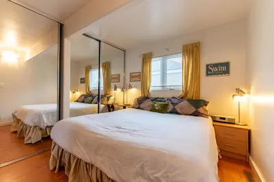 a bedroom with two beds and a large mirror at Newport Beach House 1 block from the beach FREE pickleball courts and 6 beach cruisers in Newport Beach
