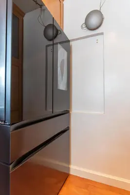 a stainless steel refrigerator in a kitchen next to a wall at Newport Beach House 1 block from the beach FREE pickleball courts and 6 beach cruisers in Newport Beach