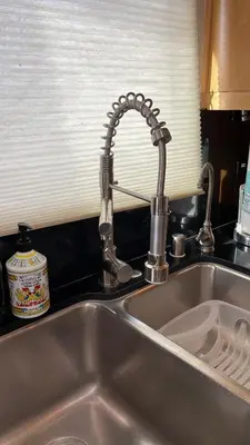 a kitchen sink with a chrome kitchen faucet at Newport Beach House 1 block from the beach FREE pickleball courts and 6 beach cruisers in Newport Beach
