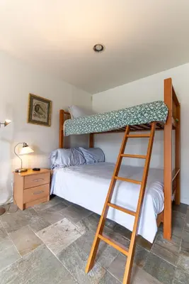 a bedroom with two bunk beds and a ladder at Newport Beach House 1 block from the beach FREE pickleball courts and 6 beach cruisers in Newport Beach