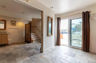 a hallway with a sliding glass door leading to a patio at Newport Beach House 1 block from the beach FREE pickleball courts and 6 beach cruisers in Newport Beach