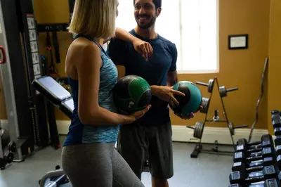 a man and a woman holding balls in a gym at The Sofia Hotel in San Diego