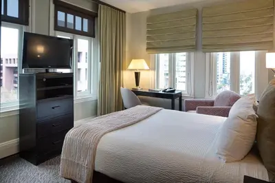 a hotel room with a bed and a television at The Sofia Hotel in San Diego