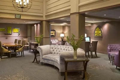 a lobby with a couch and a table and chairs at The Sofia Hotel in San Diego