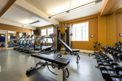 a gym with a lot of treadmills and machines at The Sofia Hotel in San Diego
