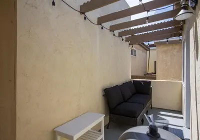 a living room with a couch and a table at MB Jamaica FLAT - Steps 2 Mission Beach in San Diego