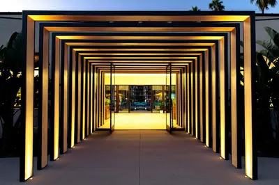 a hallway leading to a building with yellow lights at Town and Country San Diego in San Diego