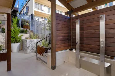 a balcony with a wooden wall and stairs at Beach Terrace in Carlsbad