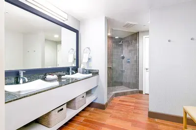 a bathroom with two sinks and a shower at Beach Terrace in Carlsbad