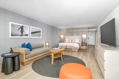 a hotel room with a bed and a television at Beach Terrace in Carlsbad