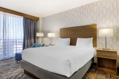 a hotel room with a large bed and a large window at Best Western Plus Bayside Inn in San Diego