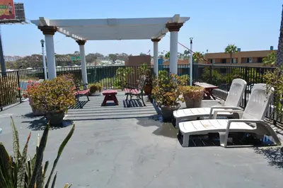 a group of chairs and tables under a gazebo at Harbor Inn & Suites Oceanside in Oceanside
