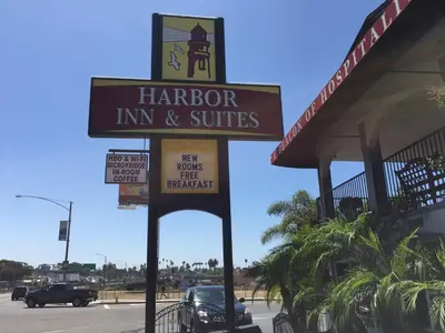 a harper inn and suites sign in front of a store at Harbor Inn & Suites Oceanside in Oceanside