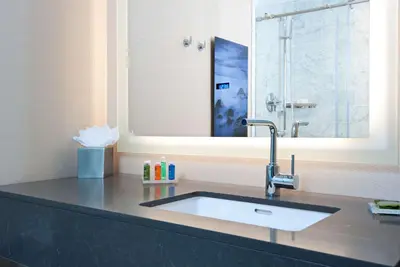 a bathroom with a sink and a mirror at Hyatt Regency Newport Beach West in Newport Beach