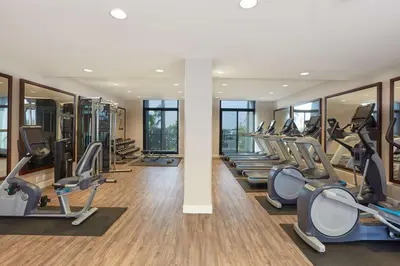 a gym with a row of treadmills and ellipticals at Hyatt Regency Newport Beach West in Newport Beach
