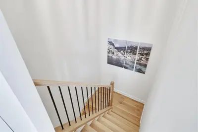 a staircase with two pictures on the wall at Beachfront feat Private Den SS166 in Solana Beach